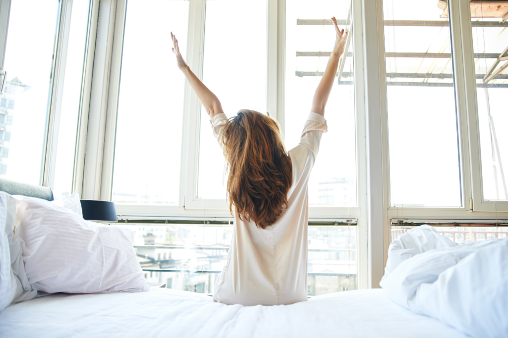 woman stretching in bed