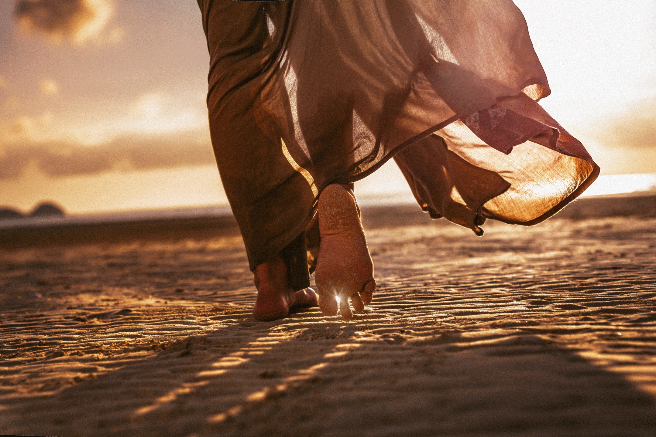 woman walking barefoot in sand